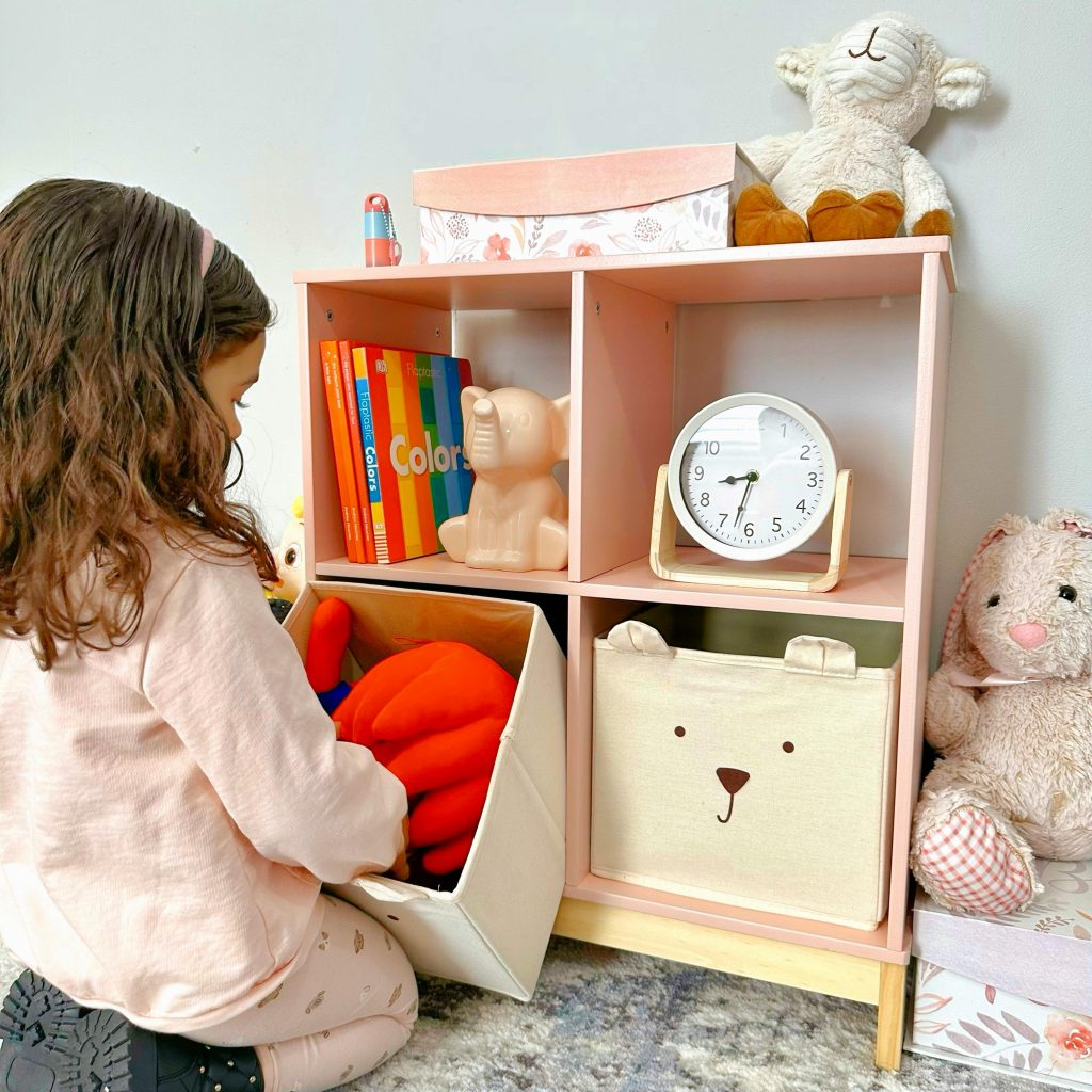 Course A child organizes toys on a colorful shelf in a cozy nursery setting.